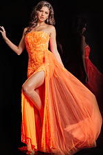 Model wearing Jovani 26134 orange dress showcasing high slit and floral pattern.