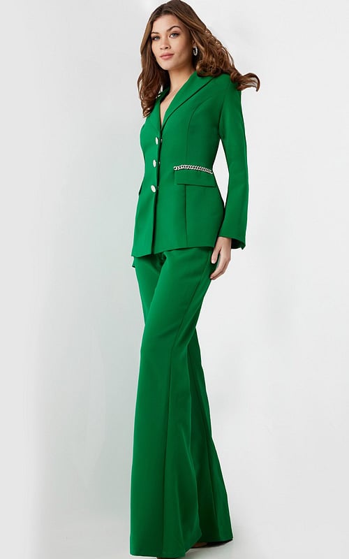 Model wearing Jovani 26144 green pantsuit with deep V-neck.