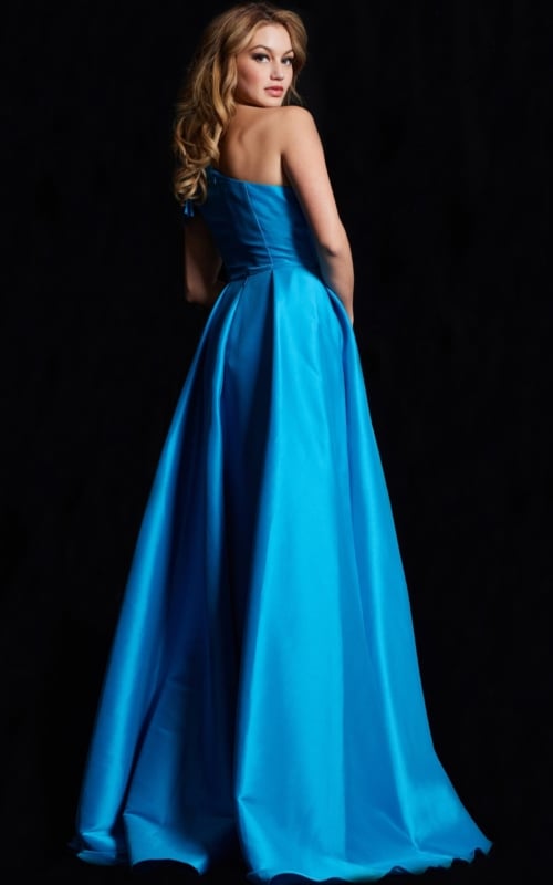 Back view of model in Jovani 26146, a blue gown with an elegant flow.