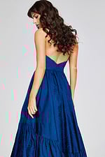 Model wearing Jovani 26152 with a navy A-line strapless gown, angled back view.