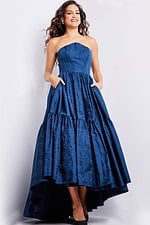 Model wearing Jovani 26152 navy dress featuring a high-low hemline.