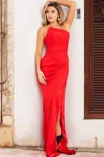 Model wearing Jovani 26166 red dress with high slit, front view.