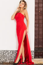 Model wearing Jovani 26166 red dress with high slit, front view.