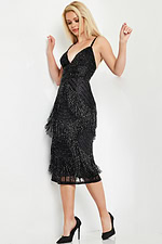 Model wearing Jovani 26192 black dress with fringe detail, side view