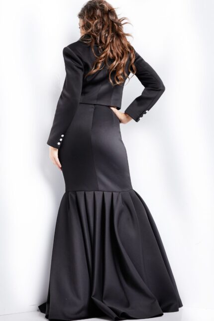 Model wearing Jovani 26199 sophisticated black dress with fishtail skirt, back view