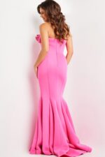 Model wearing Jovani 26200 deep pink mermaid gown with ruffle detail, back view.