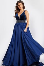 Model wearing 26201 navy gown with deep V-neckline and beaded waist, full-length front view.
