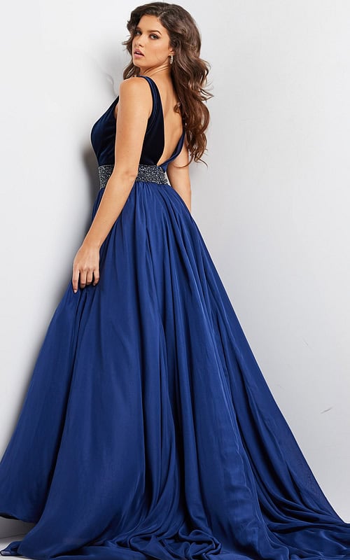 Model wearing 26201 navy gown, back view showcasing flowing silhouette.