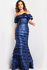 Model wearing Jovani 26255 royal blue off-the-shoulder gown with layered details and beaded waistband.