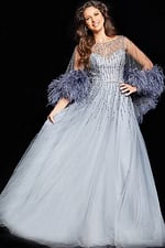 Model wearing Jovani 26265 gray dress with embellishments and feathered tulle sleeves, front view.