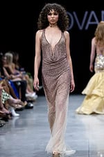 Model wearing Jovani 26268 blue sequin dress with deep V-neckline and sleeveless design.