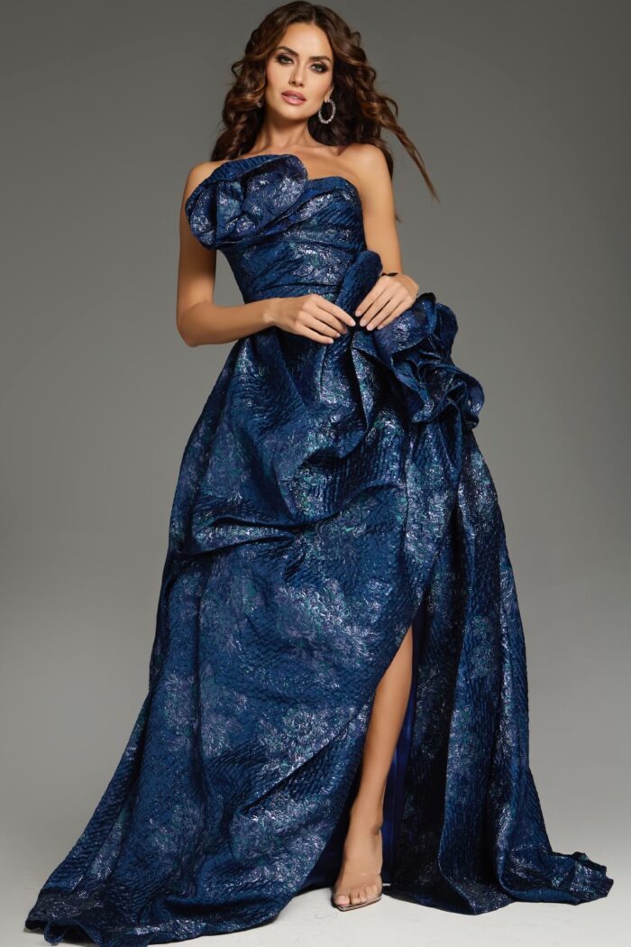 Model showcasing the Jovani 26269 navy dress with elaborate ruffles and high slit