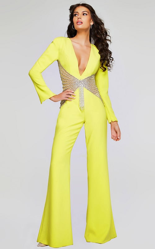 Model wearing Jovani 26318 yellow jumpsuit with V-neckline and beadwork waist.
