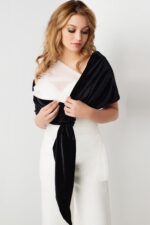 Model wearing Jovani 2750 black and white one-shoulder dress showing details from the front.