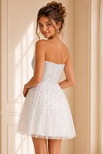 back view of white beaded strapless fit and flare dress with scattered rhinestone tulle skirt