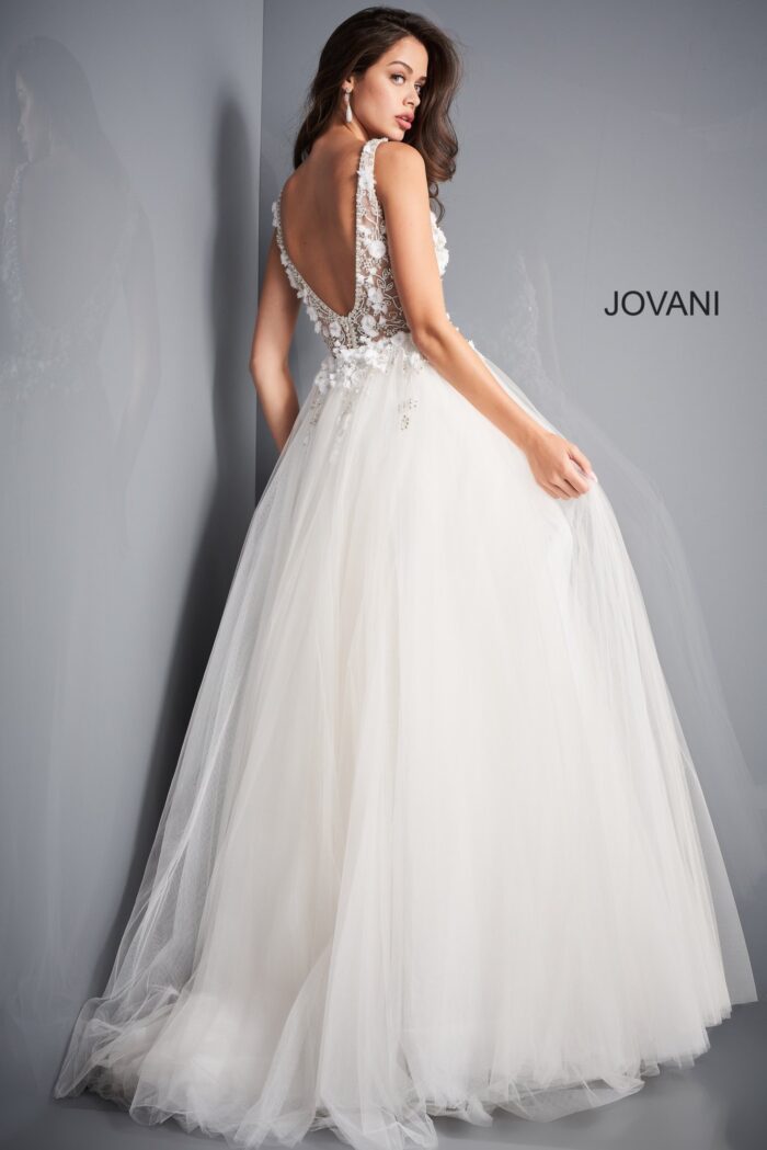 Model wearing Jovani 3110 ivory ballgown, back view showing details.