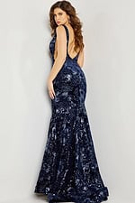Model showcasing the back of Jovani 32581 gown with low-cut back design.