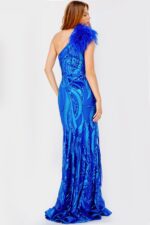 Model showcasing the back of Jovani 32596 gown in royal blue with feather embellishment.