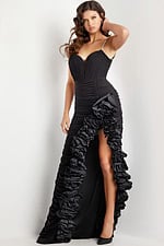 Model wearing Jovani 34392 black gown featuring a sweetheart neckline and high slit with ruffles.