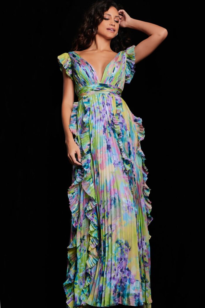 Model in Jovani 34412 floor-length print dress, with V-neckline and ruffled details, front view