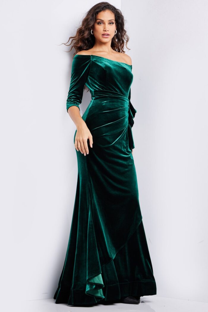 model wearing 36458 green velvet dress with off-the-shoulder neckline and three-quarter sleeves