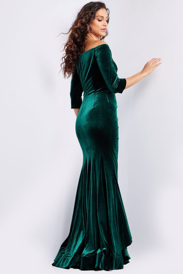 back view of model wearing 36458 green velvet dress with off-the-shoulder detail