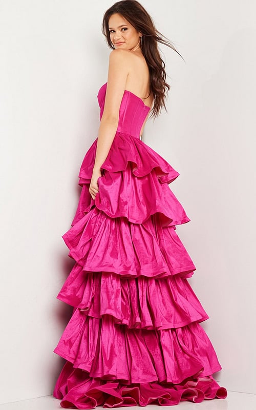 Model wearing Jovani 36619 fuchsia ball gown, side view.