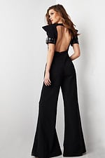 model wearing Jovani 36692 black jumpsuit with open back design