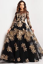 Model wearing Jovani 36716 black gown with gold floral embroidery, front view.