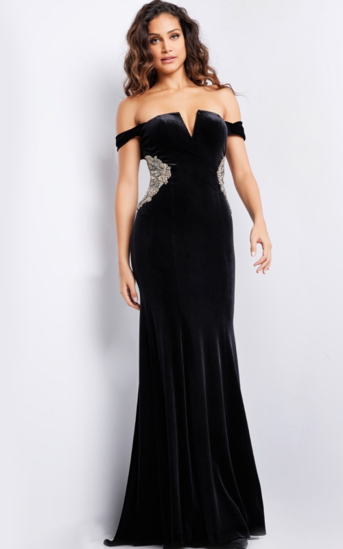 Model wearing Jovani 36733 black off-the-shoulder gown with side embellishments, front view.