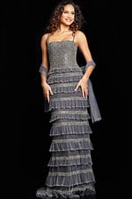 Model in Jovani 36816 silver gown with square neckline and tiered ruffle design.