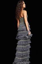 Back view of model wearing Jovani 36816 silver gown showcasing intricate design and layered ruffles.
