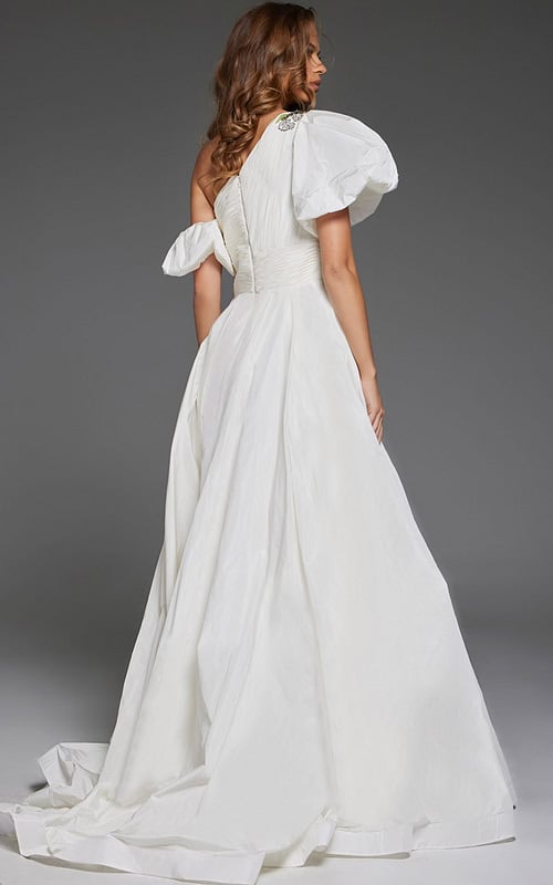 model wearing Jovani 36872 white one-shoulder gown with floral embellishments and high slit