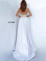 Back view of model wearing Jovani 3698 nude gown with flowing train.
