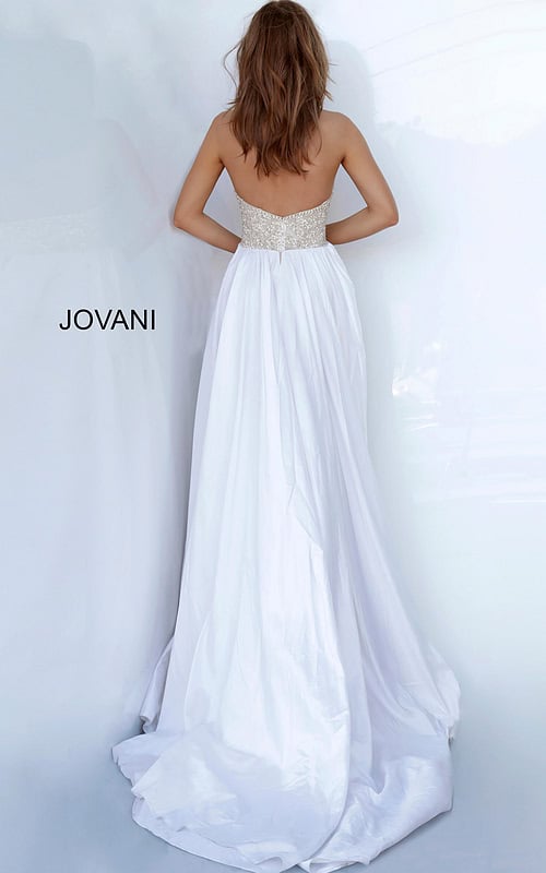Back view of model wearing Jovani 3698 nude gown with flowing train.