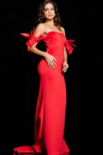 Model wearing Jovani 36997 red gown with dramatic bow details on the sleeves.