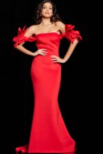 Model wearing Jovani 36997 red floor-length gown featuring a mermaid silhouette and dramatic bow details.