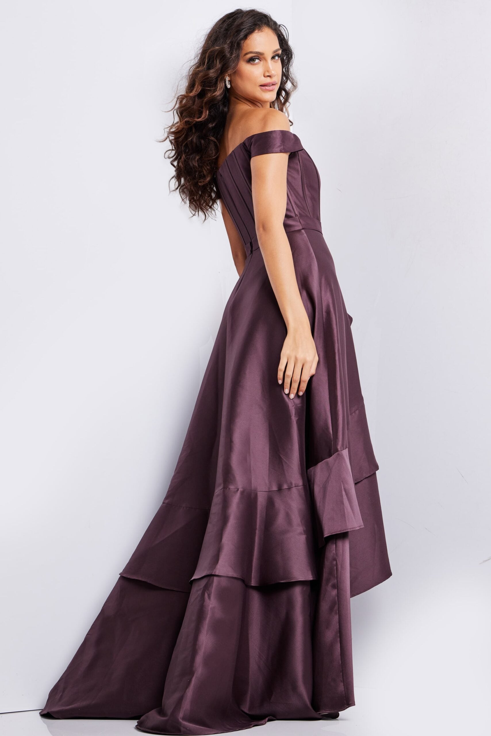 Back view of model in Jovani 37014 brown dress, showcasing the flowing layered skirt.