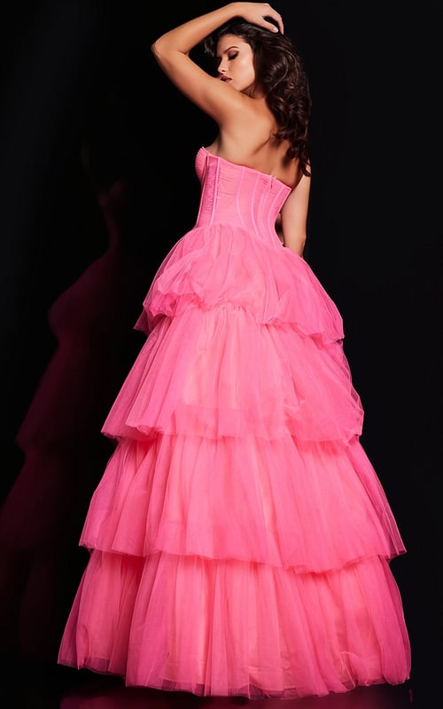 Model wearing Jovani 37062 pink gown with tiered skirt, back view.