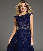 model in Jovani 37070 navy dress showing embroidered bodice