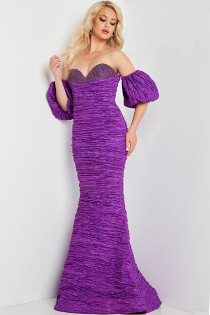 Model wearing Jovani 37072 purple dress from the back featuring puff sleeves and mermaid silhouette.