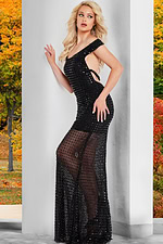 Front view of Jovani 37100 black gown worn by model in a garden setting