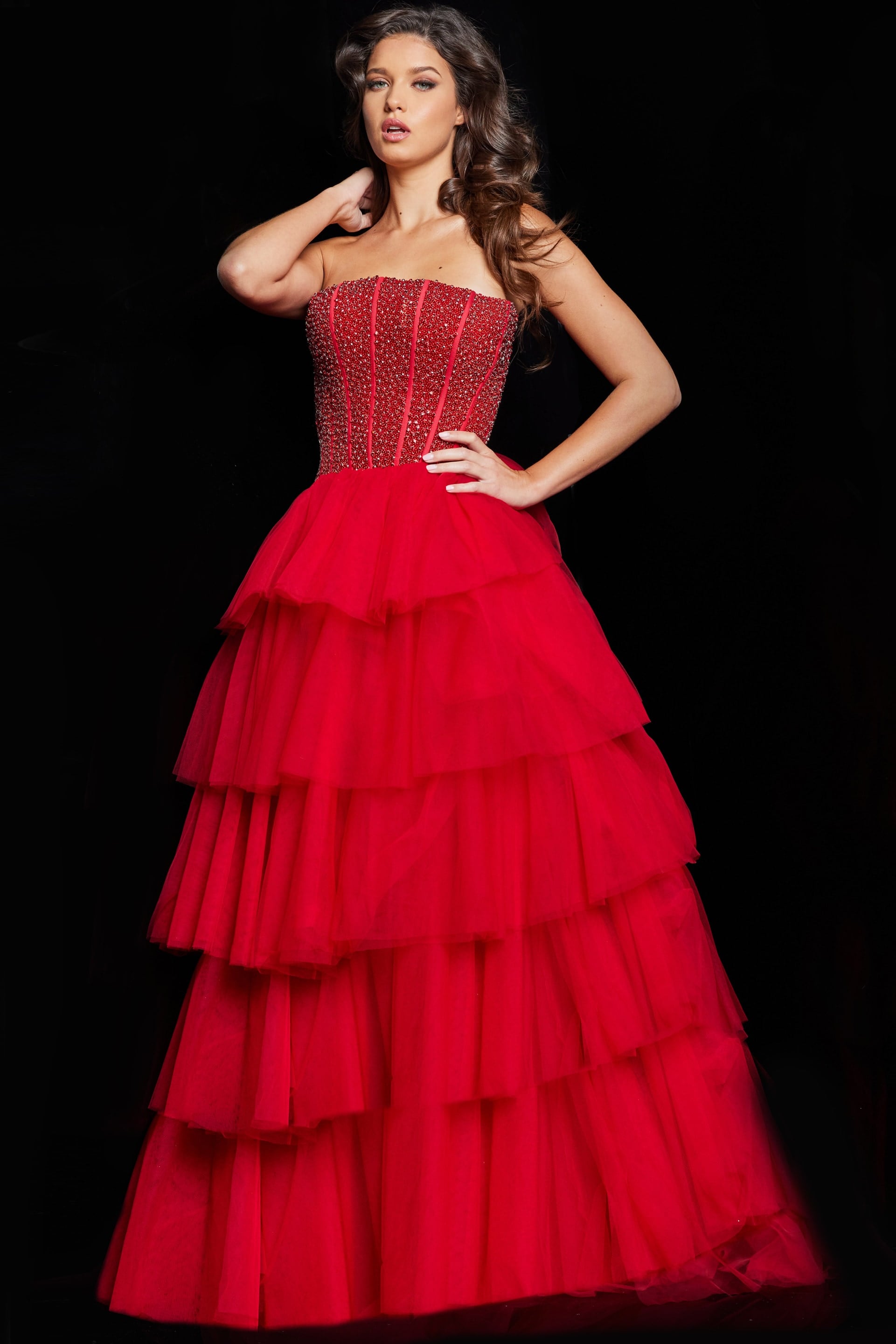 37210_RED_29-2.jpg Model wearing Jovani 37210 strapless red gown with tiered tulle skirt, front view.