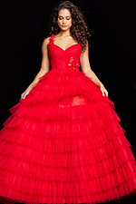 Model showcasing Jovani 37274 red dress's tiered skirt and floral shoulder appliqué.