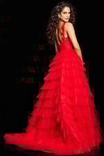 Model wearing Jovani 37274 red gown, back view showing layered tulle skirt.
