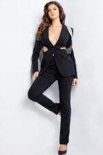 Model wearing Jovani 37347 in a black tailored pantsuit with long sleeves and cut-outs.