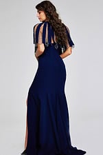 Model in Jovani 37386 navy dress showcasing back and side view with high slit details.