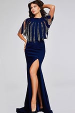 Model wearing Jovani 37386 navy dress front view featuring jewel neckline and cape sleeves with high slit.
