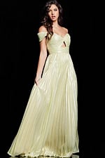 Model wearing Jovani 37389 yellow gown with A-line silhouette and slit