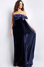 Full-length view of model in Jovani 37391 navy off-the-shoulder gown with asymmetrical bow.